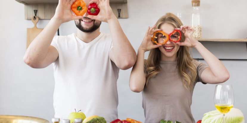 smiling-couple-playing-with-bell-pepper